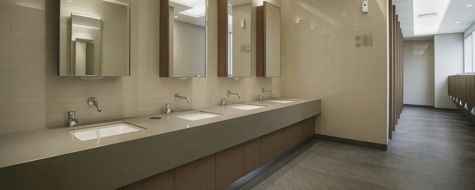 High-traffic commercial restroom with durable FontanaTouchlessFaucets finishes